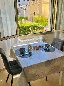 a table with a blue table cloth on it with a window at Charmant Studio en bord de Mer in Nice