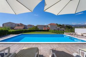 a swimming pool in the backyard of a house at Modern apartment with private pool near Split in Podstrana