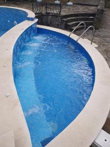 ein großer Pool mit blauem Wasser in der Unterkunft Family Hotel Chiflik Hills in Chiflik