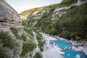 a river in the mountains with blue water at Auberge des deux vallées in Ribiers