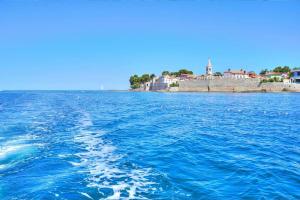 a view of the ocean from a boat in the water at Holiday Erna - Apartments Cherry & Blue in Novigrad Istria