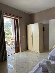 a bedroom with a bed and a door to a patio at Villa Tatiana in Borsh