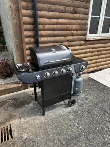 a grill sitting next to a house at Mac's Cottage in Clogher