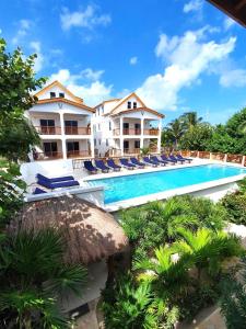 a view of a resort with a swimming pool at VeLento Partial Ocean View #8 in Caye Caulker