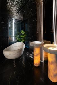 a bathroom with a large marble tub and a plant at Chandelier Sky Mansion in Prague