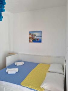 a bedroom with a bed with two towels on it at Jasmine Summer House in Kalo Chorio