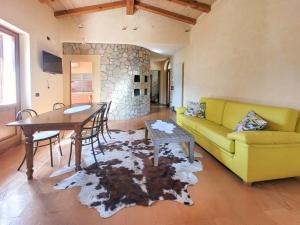 a living room with a yellow couch and a table at Villa Fior di Loto in Limone sul Garda