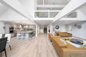 a large living room with couches and a kitchen at Big Villa,4 Masters, Heated Pool, Hot Tub, Sauna in Blakeslee