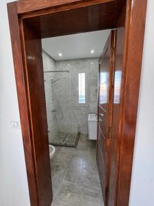a bathroom with a shower and a toilet in it at Villa Lucia in Djerba