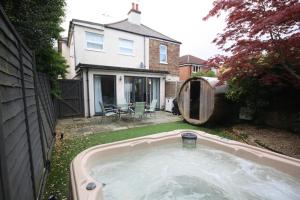 a hot tub in the backyard of a house at Bournemouth Hot Tub & Sauna Holiday Let in Bournemouth