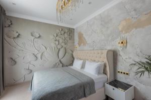 a bedroom with a bed with a floral wallpaper at Arcadia Plaza Hotel in Odesa +137 photos