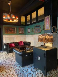 a living room with leather couches and a table at The Nolita Express 1927 Hostel in New York