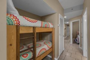 a couple of bunk beds in a room at Tradewinds 001 by Vacation Homes Collection in Orange Beach