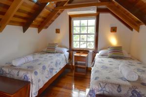 a bedroom with two beds and a window at Hidden Gem Cabana in Caye Caulker