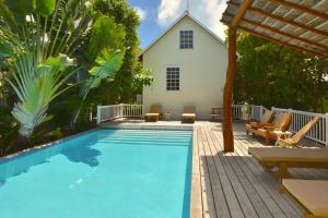 a swimming pool with a house in the background at Hidden Gem Cabana in Caye Caulker