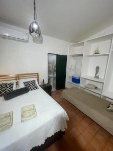 a bedroom with a large bed with white shelves at Espaço Brilho do Sol Genipabu in Extremóz