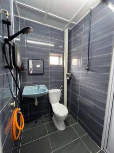 a small bathroom with a toilet and a sink at 3Homestay Bentong in Bentong +16 photos