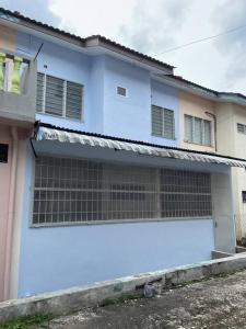 a white house with a blue garage door at 3Homestay Bentong in Bentong