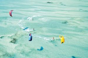 a group of people flying kites in the water at Une pause s'impose au Vauclin avec votre jacuzzi privatif pour 3 nuits minimum in Le Vauclin