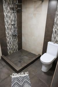 a bathroom with a shower with a toilet and a shower at Casanova Inn - Boutique Hotel in Dilijan