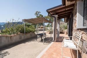 a patio with a table and chairs on a house at casa Luna in Dorgali