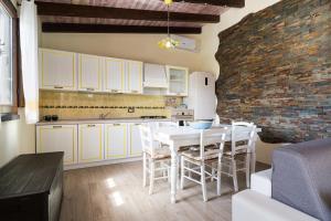 a kitchen and dining room with a white table and chairs at casa Luna in Dorgali
