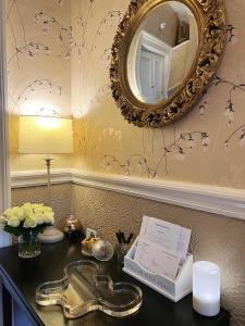 a bathroom with a sink and a mirror on a wall at Gladstone House in Edinburgh