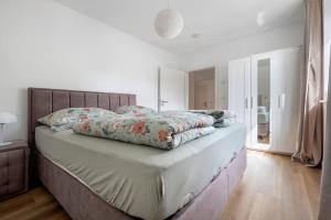 a bedroom with a large bed with a wooden floor at Eidelstedt Zentrale Lage in Hamburg
