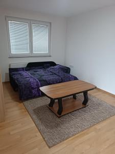 a bedroom with a coffee table and a bed at 2BDR Apt with Balcony view - Free parking 2 in Sarajevo