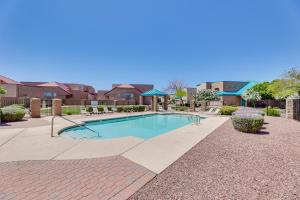 a swimming pool in the middle of a yard at Mesa Townhome with Community Perks Close to Golf! in Mesa