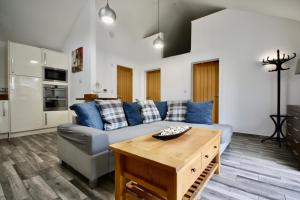 a living room with a couch and a table at Ferndown Holiday Let in Ferndown