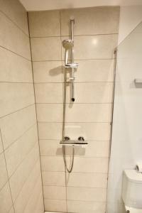 a shower with a shower head in a bathroom at Ferndown Holiday Let in Ferndown