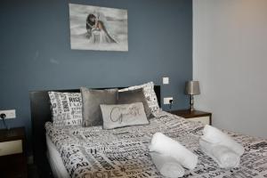 a bedroom with a bed with white sheets and pillows at Ferndown Holiday Let in Ferndown