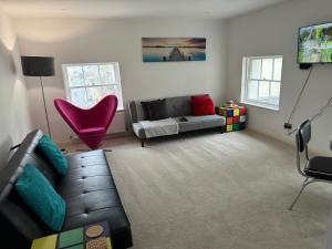 a living room with a couch and a chair at Russell square Apartment 4 city in Brighton & Hove