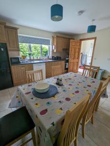 a kitchen with a table with a table cloth on it at 4 Bed House, spacious & modern with parking Tubbercurry in Tobercurry