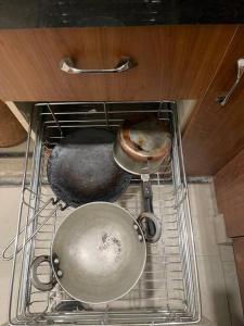 two pots and pans sitting on top of a stove at Luxurious 2BHK Flat/South Delhi/Prime Location in New Delhi