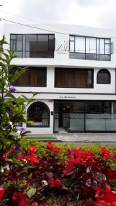 a white building with flowers in front of it at Hotel AG Boutique in Bogotá