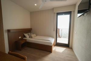 Ένα ή περισσότερα κρεβάτια σε δωμάτιο στο Albergo Deva