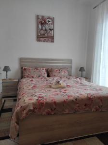 a bedroom with a large bed with a red bedspread at S.T Family Apartement in Kalabaka +21 photos