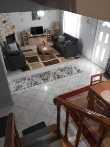 a living room with a couch and a table at S.T Family Apartement in Kalabaka