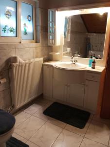 a bathroom with a sink and a mirror at S.T Family Apartement in Kalabaka +21 photos