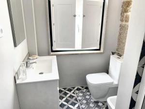 y baño con lavabo, aseo y espejo. en One bedroom house with city view balcony and wifi at Castelo Branco, en Castelo Branco