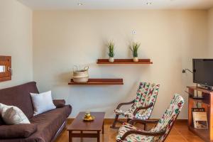 a living room with a couch and two chairs at Ses Angoixes in Santanyi