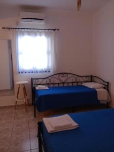 Postel nebo postele na pokoji v ubytování Meltemi Rooms and Studios