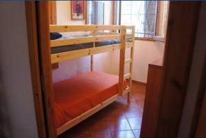 two bunk beds in a room with a window at VILLA CATERINA in Calasetta