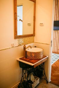een badkamer met een wastafel en een spiegel bij Joseph Hayn Apartments in Sighişoara