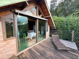 a house with a deck with a table on it at Reserva Santo Antônio in Santo Antônio do Pinhal