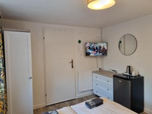 a bedroom with a refrigerator and a mirror at Pokoje goscinne Gala in Międzyzdroje