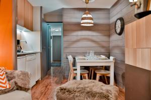 a dining room with a white table and chairs at IMMODREAMS - Le Choucas - Avoriaz in Avoriaz +6 photos