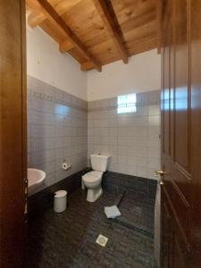 a bathroom with a toilet and a tub and a sink at Guesthouse Platon in Orma +65 photos